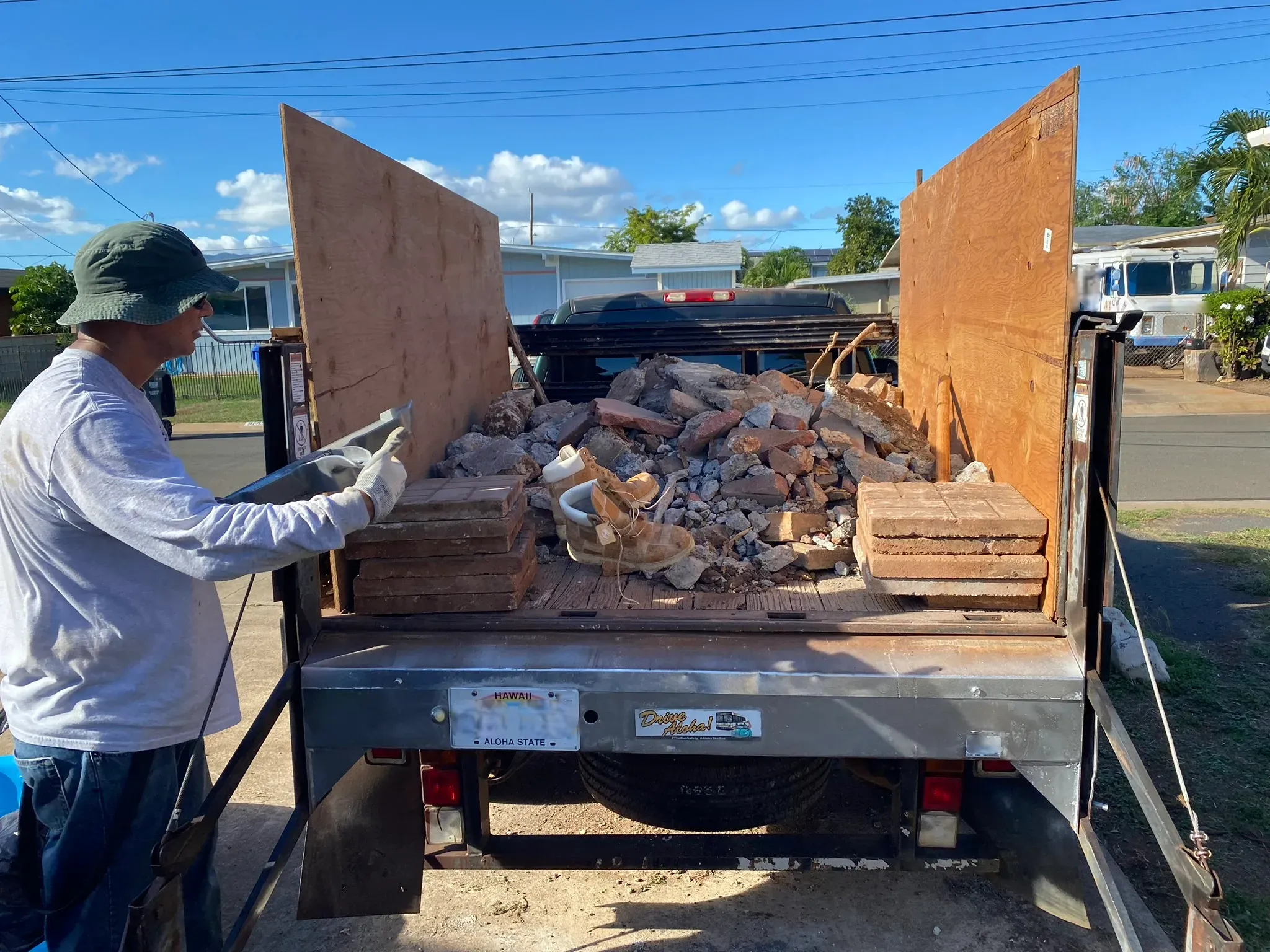 JunkForce team loading company vehicle with garbage